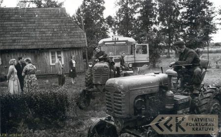 The expedition bus stuck in the mud of a folklore informant's yard